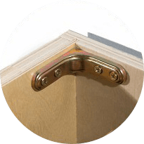 Close-up of a metal corner brace inside a base cabinet