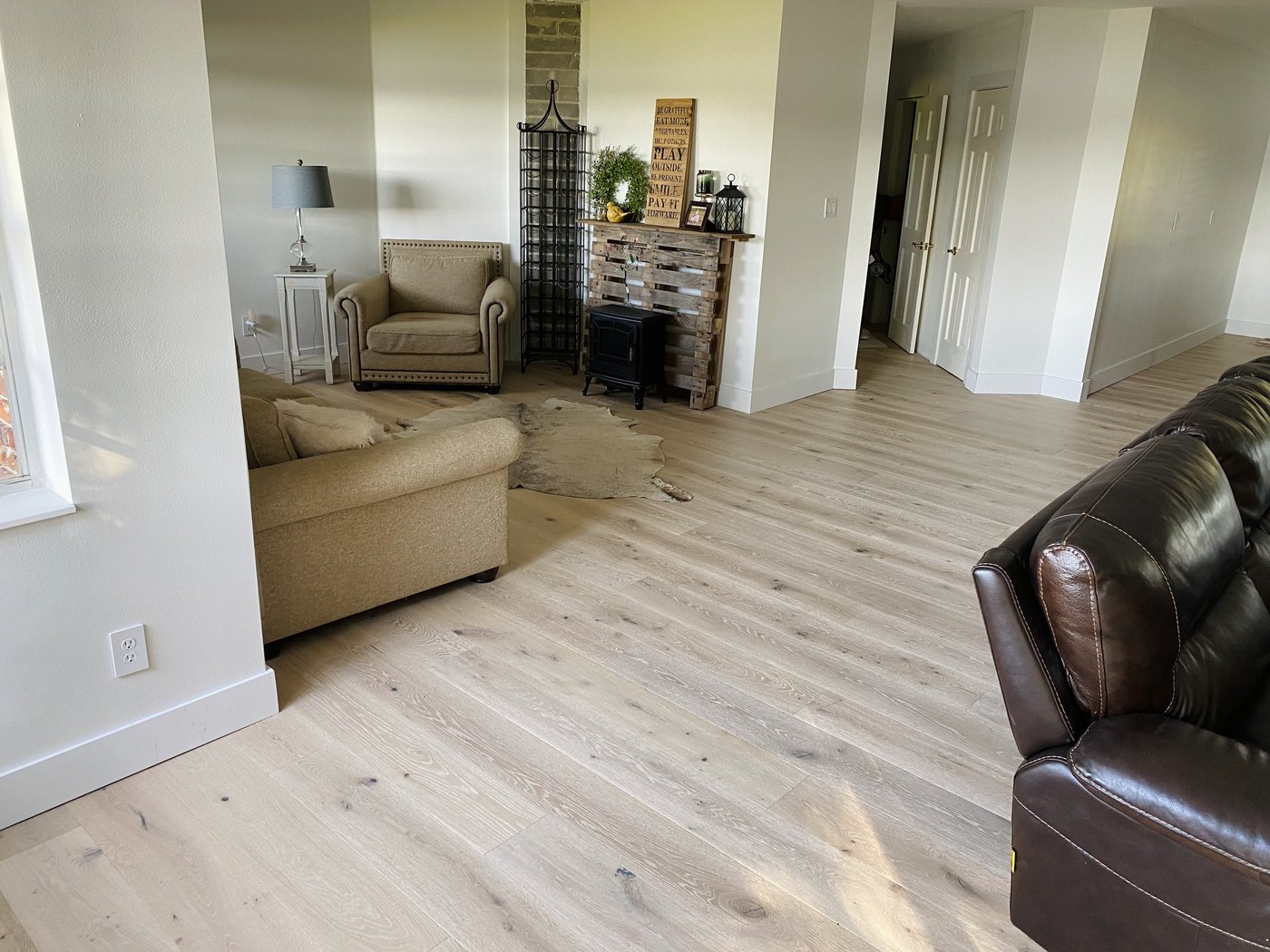 Living room with light oak wide-plank flooring
