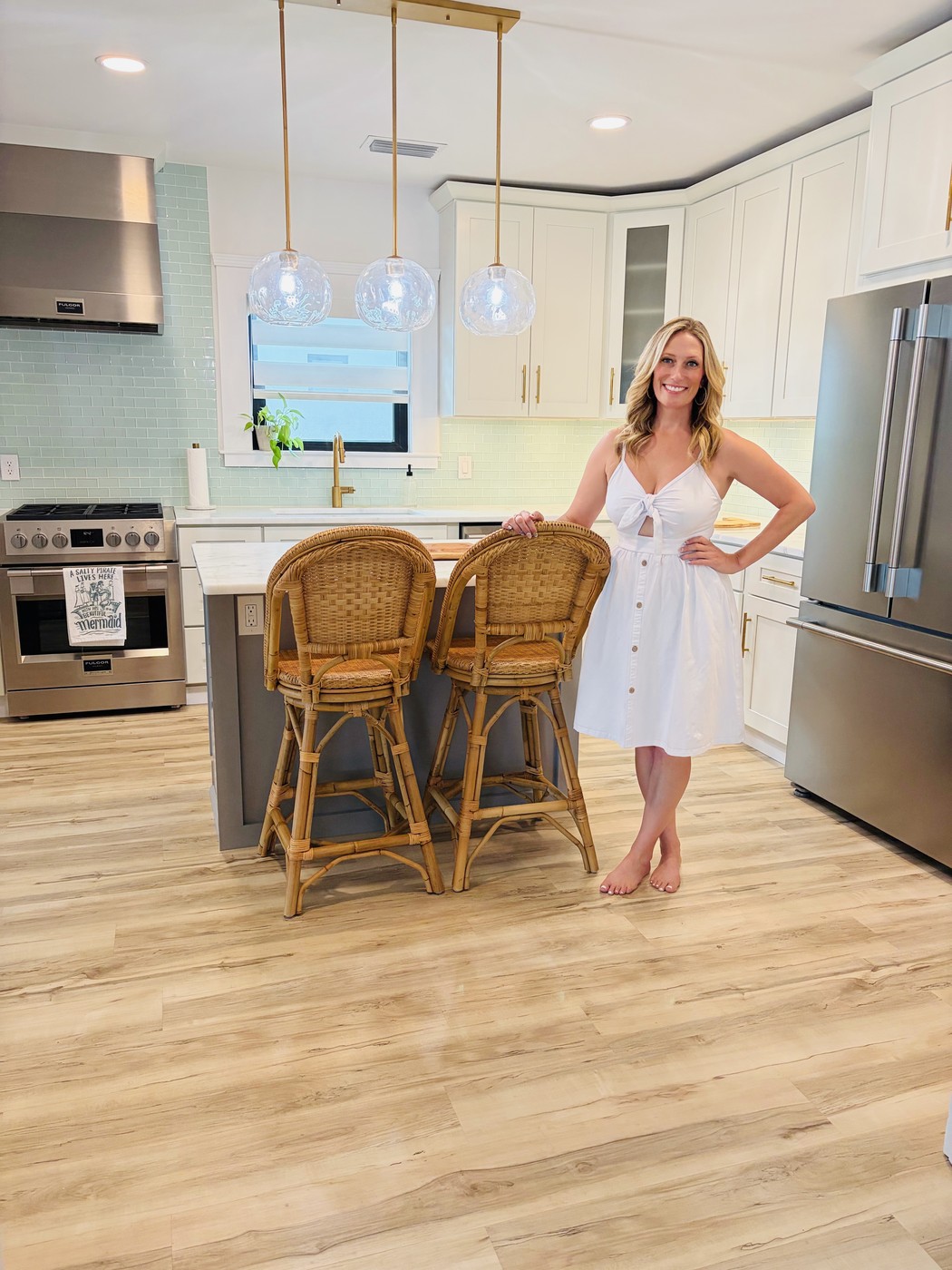 Samantha, owner of Cabinet Savvy Studio, in a finished white kitchen